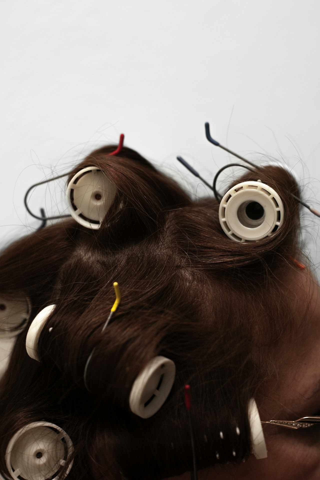 Hair set in colourful curlers, captured close up